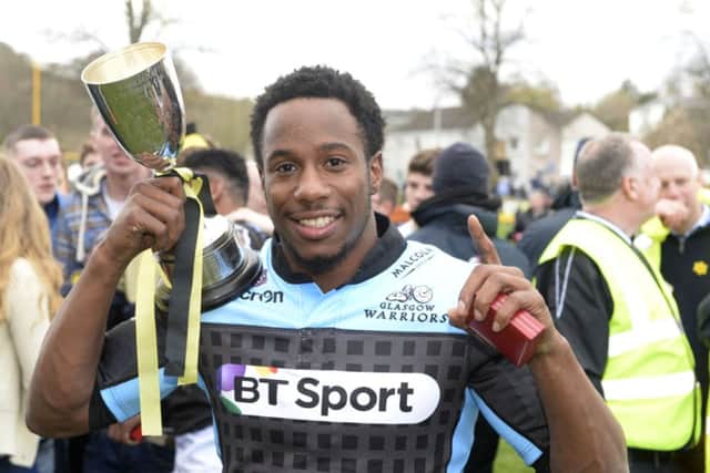 Glasgow's Carlin Isles celebrates with the Melrose Sevens trophy. Picture: SNS