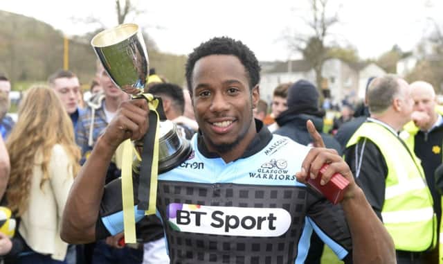 Glasgow's Carlin Isles celebrates with the Melrose Sevens trophy. Picture: SNS