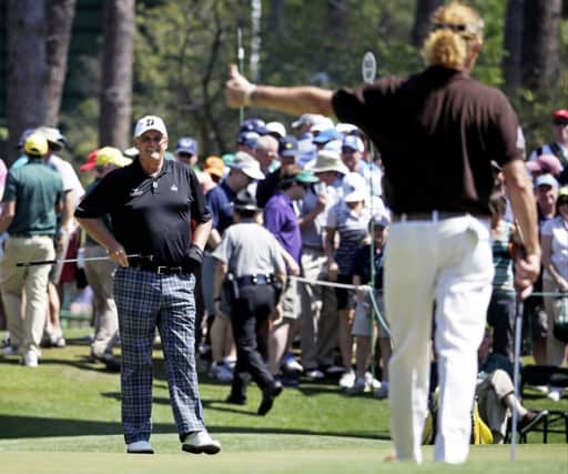 Miguel Angel Jimenez gives Sandy Lyle a thumbs-up after Lyle's birdie on the sixth. Picture: AP