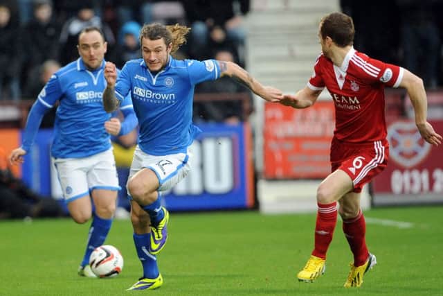 St Johnstone's Stevie May breaks through chased by Mark Reynolds. Picture: Ian Rutherford
