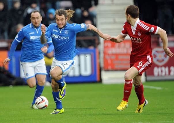 St Johnstone's Stevie May breaks through chased by Mark Reynolds.  Picture: Ian Rutherford