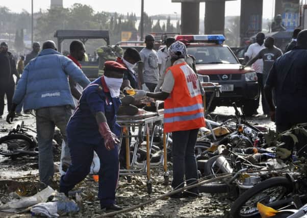 Rescue workers work to recover victims at the site of the blast in Abuja, Nigeria. Picture: AP