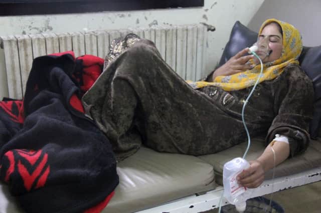 A woman  affected by what opposition activists say was a gas attack, in Kfar Zeita village. Picture: Reuters
