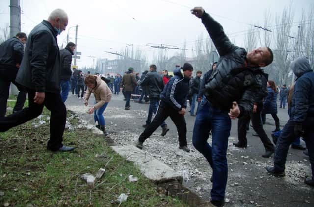 Pro-Russia protesters throw stones as they stormed a police building in Horlivka. Picture: Getty