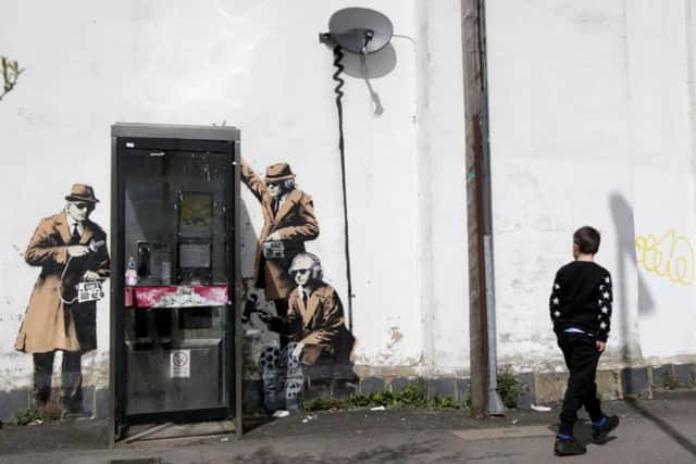 A boy walks past a piece of new graffiti street art, claimed to be by the secretive underground guerilla artist Banksy, in Cheltenham. Picture: Getty