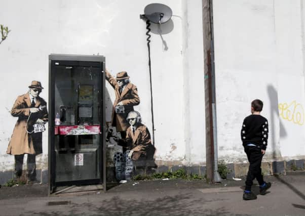 A boy walks past a piece of new graffiti street art, claimed to be by the secretive underground guerilla artist Banksy, in Cheltenham. Picture: Getty