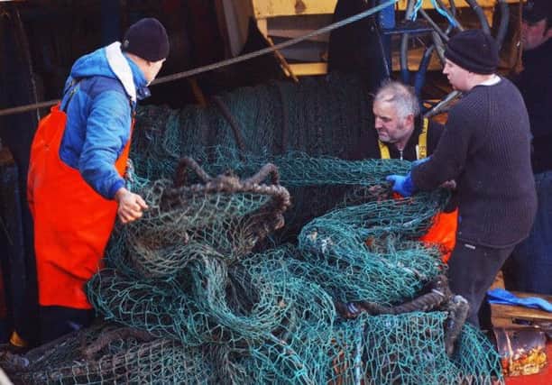 Fishermen work in the harbour at Pittenweem where the main catch is now prawns, ratehr than haddock. Picture:PA
