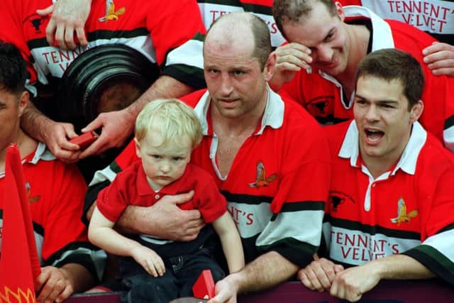 Fergus Wallace holds his son, also Fergus, during the celebrations after their win over Kelso. Picture: TSPL
