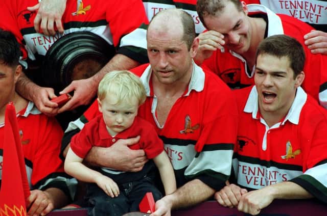 Fergus Wallace holds his son, also Fergus, during the celebrations after their win over Kelso. Picture: TSPL