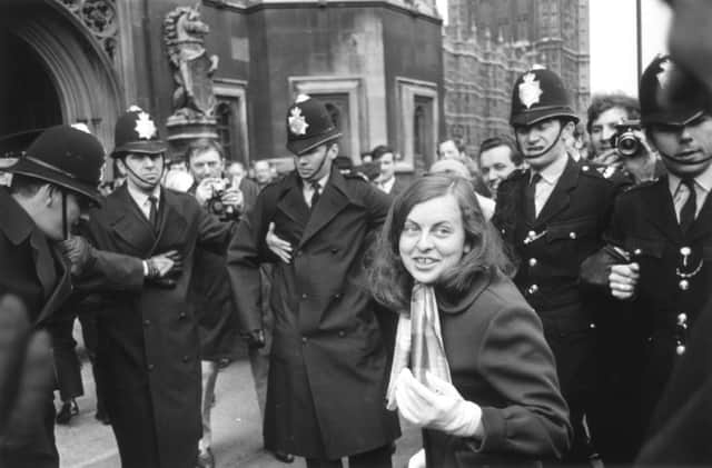 Police form a cordon around Bernadette Devlin as she arrives at the House of Commons to deliver her maiden speech. Picture: Getty
