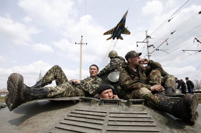Ukrainian soldiers sit on an armoured personnel carrier in Kramatorsk. Picture: Reuters