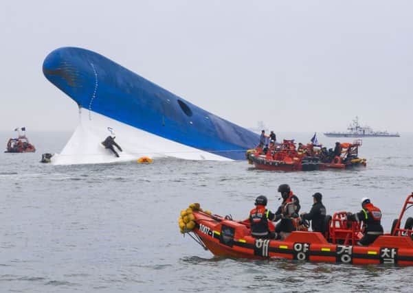 Coast guard members search for passengers near the capsized ferry. Picture: Getty