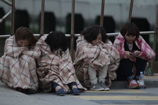 Relatives of missing people wait at a Jindo port. Picture: Getty