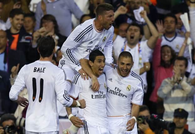 Angel de Maria celebrates with Karim Benzema, right, Sergio Ramos, top, and Gareth Bale. Picture: Reuters