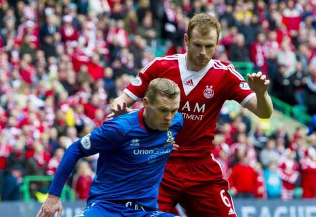 ICT striker Billy McKay shields the ball from Mark Reynolds. Picture: SNS