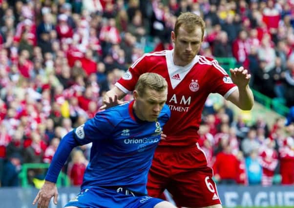ICT striker Billy McKay shields the ball from Mark Reynolds. Picture: SNS