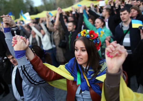 Ukrainian people hold hands at a pro-unity rally in the eastern city of Donetsk. Picture: AFP
