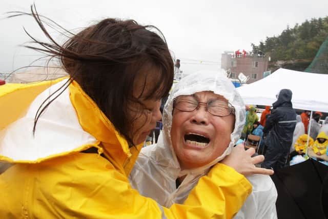 A relative weeps as she waits for missing passengers of a sunken ferry at Jindo port. Picture: Getty
