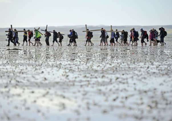 Christians make the journey across the Lindisfarne mudflats today in glorious sunshine. Picture: Phil Wilkinson