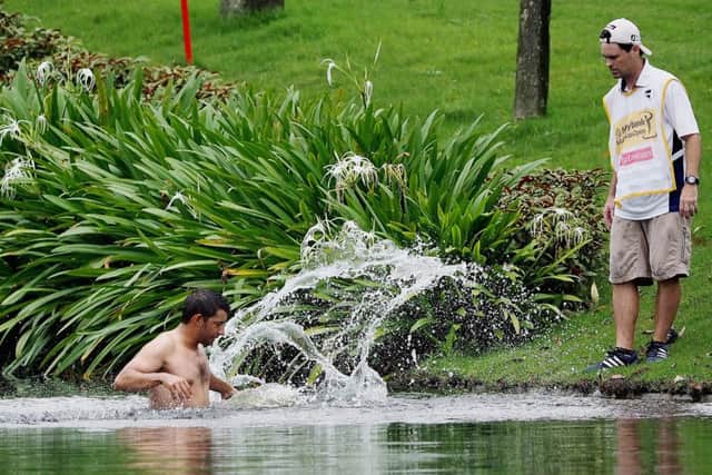 Spain's Pablo Larrazabal jumps into a water hazard in an attempt to avoid attacking hornets during round two of the 2014 Malaysian Open
Picture: Getty