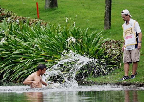 Spain's Pablo Larrazabal jumps into a water hazard in an attempt to avoid attacking hornets during round two of the 2014 Malaysian Open
Picture: Getty