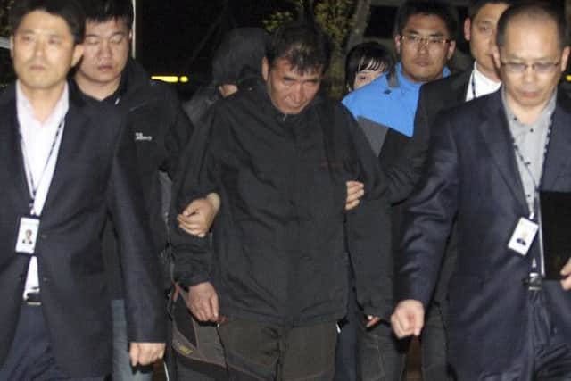 Lee Joon-seok, center, the captain of the sunken ferry, arrives at court south of Seoul. Picture: AP