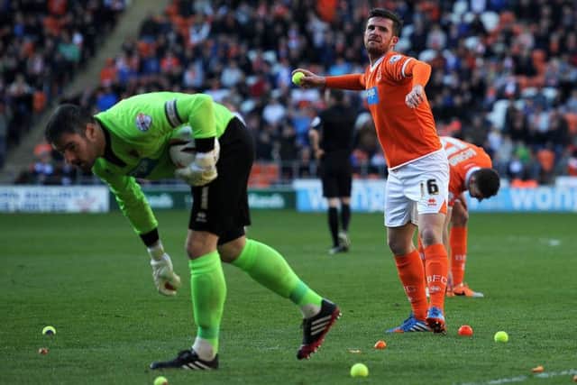 A frustrated Blackpool player-manager Barry Ferguson throws a tennis ball off the pitch. Picture: PA