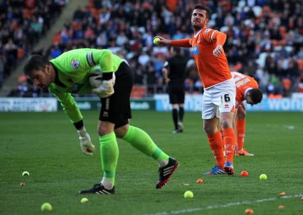 A frustrated Blackpool player-manager Barry Ferguson throws a tennis ball off the pitch. Picture: PA