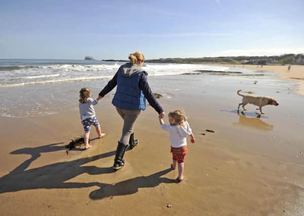 Helen Nisbet and daughters Isla, 4, and Lauren, 2, enjoy the weather at North Berwick beach. Picture: Phil Wilkinson