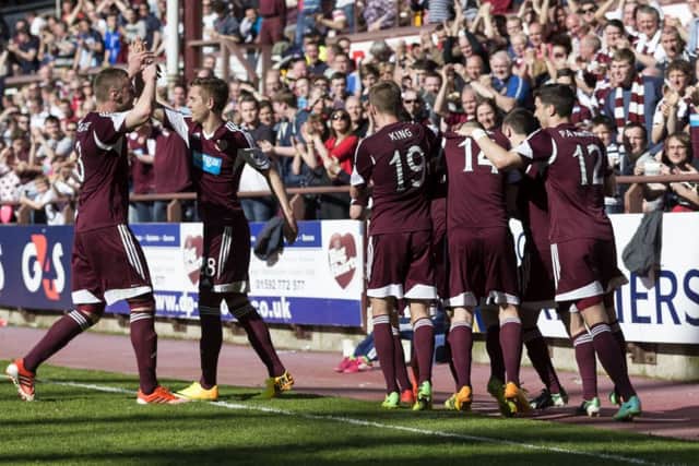 Hearts players celebrate Jamie Hamills opener, although the goalscorer was dismissed moments later. Picture: SNS