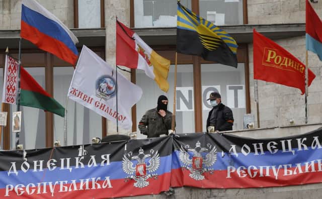 ProRussian protesters stand outside a regional administration building. Picture: AP