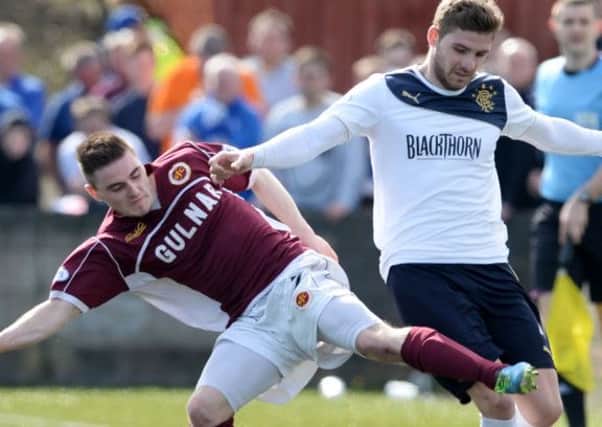 Kyle Hutton tries to fend off Stenhousemuir's Sean Dickson at Ochilview yesterday. Picture: SNS