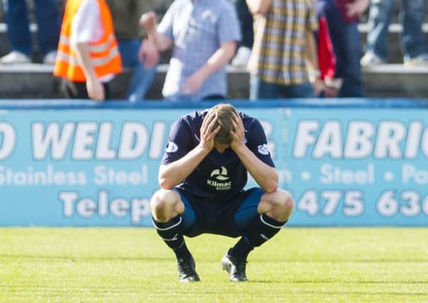 Dundees Willie Dyer shows his despair as his side are knocked off the top of the table with two games left. Picture: SNS