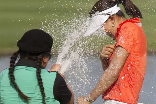 Michelle Wie is sprayed in champagne by Christina Kim after her win on home soil in Hawaii in the LOTTE Championship. Picture: AP