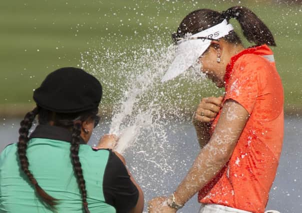 Michelle Wie is sprayed in champagne by Christina Kim after her win on home soil in Hawaii in the LOTTE Championship. Picture: AP