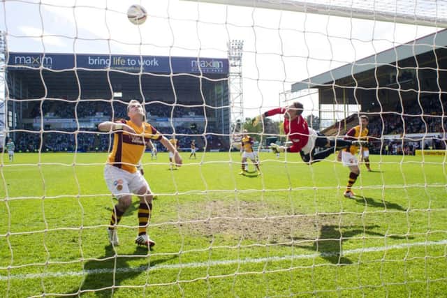 Steven Hammell and goalkeeper Gunnar Nielson are helpless to stop  this curling effort by Celtics Anthony Stokes. Picture: SNS