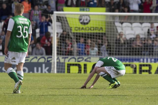 Hibs players Jason Cummings and Sam Stanton appear demoralised following the final whistle at St Mirren Park. Picture: PA