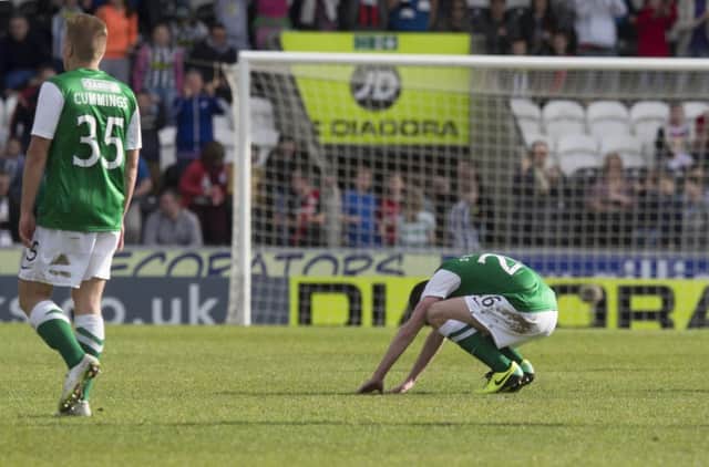 Hibs players Jason Cummings and Sam Stanton appear demoralised following the final whistle at St Mirren Park. Picture: PA