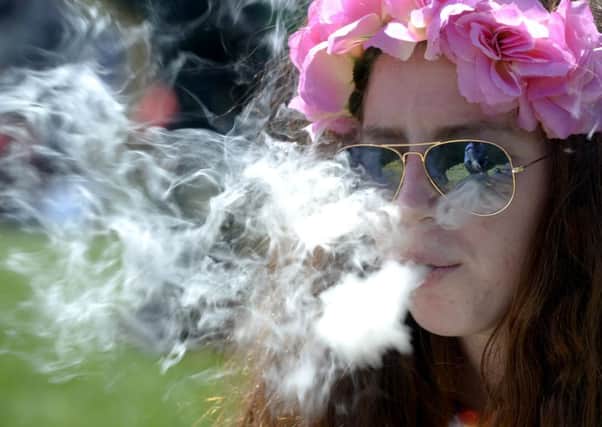 A woman smokes marijuana during the rally in Denver. Picture: Reuters