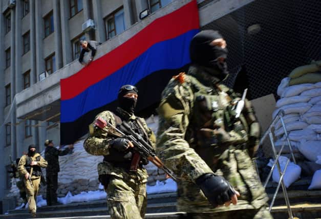 Armed men guard a captured building in the socalled Peoples Republic of Donetsk. Picture: AFP/Getty