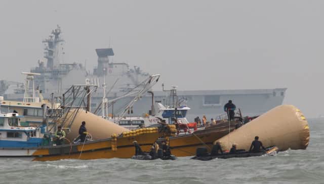 Divers continue the painstaking process of searching the upturned Sewol for the bodies of those missing. Picture: AP