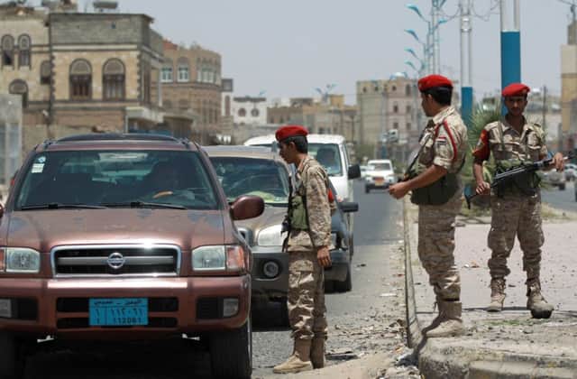 Yemeni soldiers check vehicles passing through Sanaa yesterday as security is tightened in the country. Picture: AFP/Getty