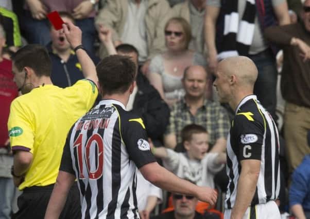 Jim Goodwin (right) looks stunned as referee Kevin Clancy flashes the red card. Picture: PA