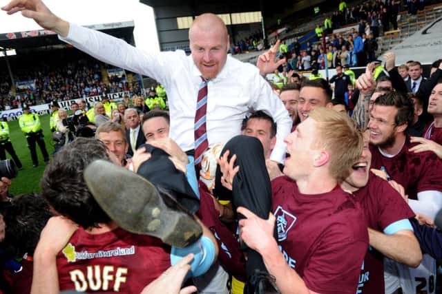 Sean Dyche celebrates with his players after their win over Wigan secured promotion to the Premier League. Picture: PA