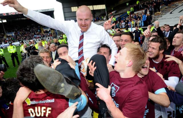 Sean Dyche celebrates with his players after their win over Wigan secured promotion to the Premier League. Picture: PA