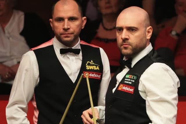Jamie Burnett, left, says he lost interest during his defeat by Joe Perry yesterday. Picture: Getty
