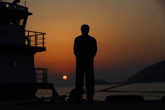 A man on Jindo island prays for the dead and missing passengers of capsized ferry. Picture: Reuters