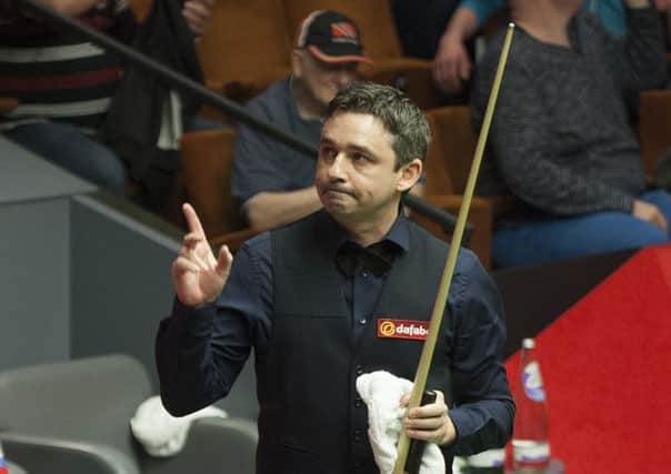 Alan McManus acknowledges the audience as he leaves the arena following his victory. Picture: PA