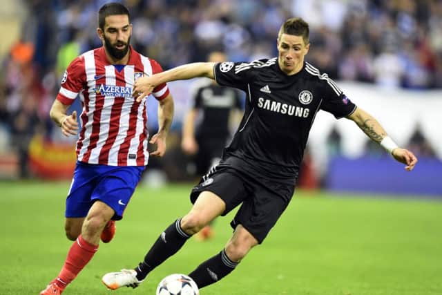 Atletico Madrid's Turkish midfielder Arda Turan vies with Chelsea's Fernando Torres. Picture: Getty