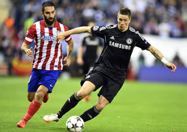 Atletico Madrid's Turkish midfielder Arda Turan vies with Chelsea's Fernando Torres. Picture: Getty